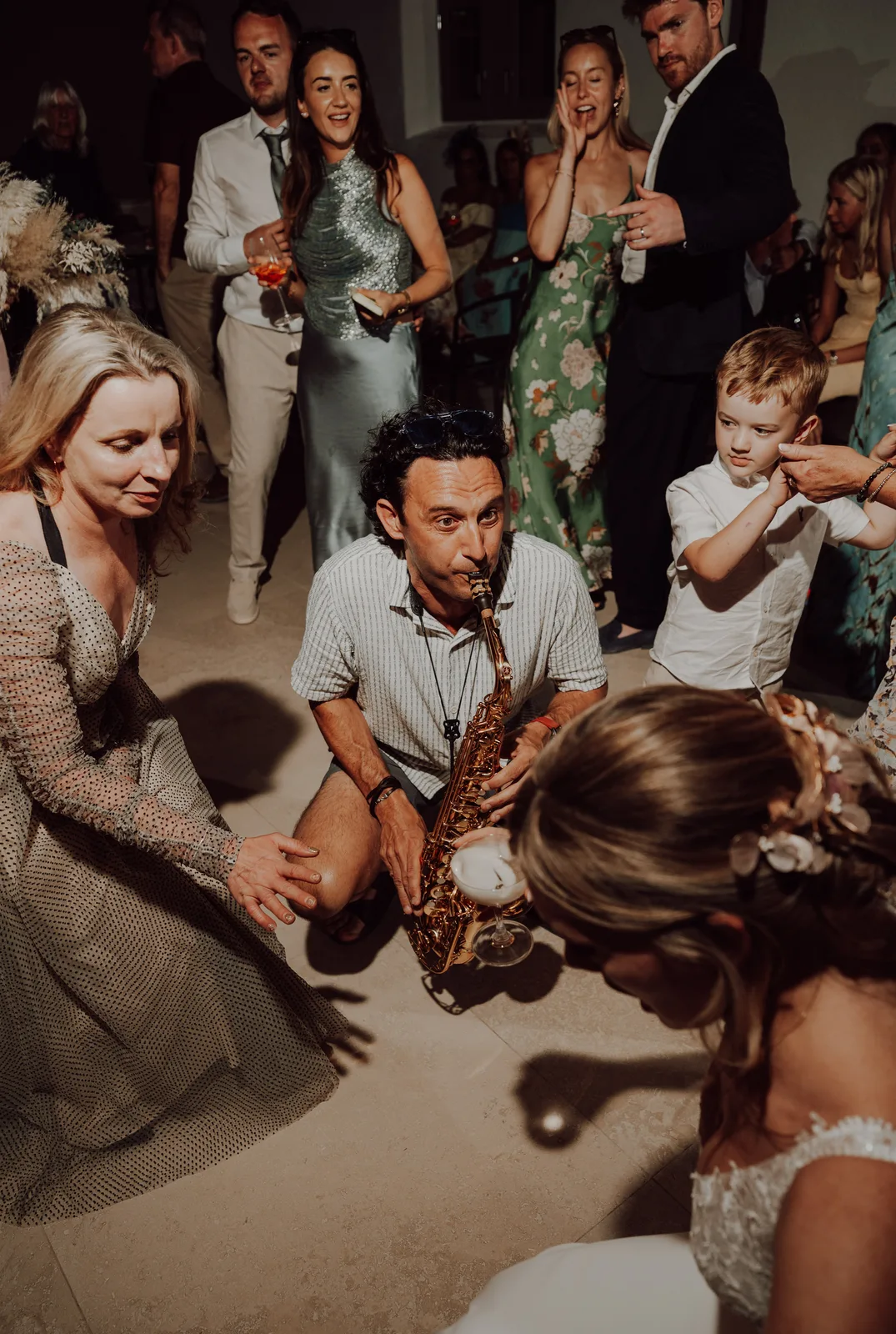 Tom playing saxophone in the middle of a dance floor